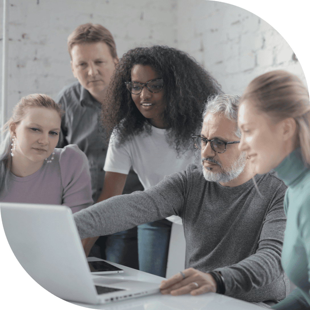 group of people looking at laptop