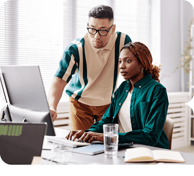 man and woman working at a laptop